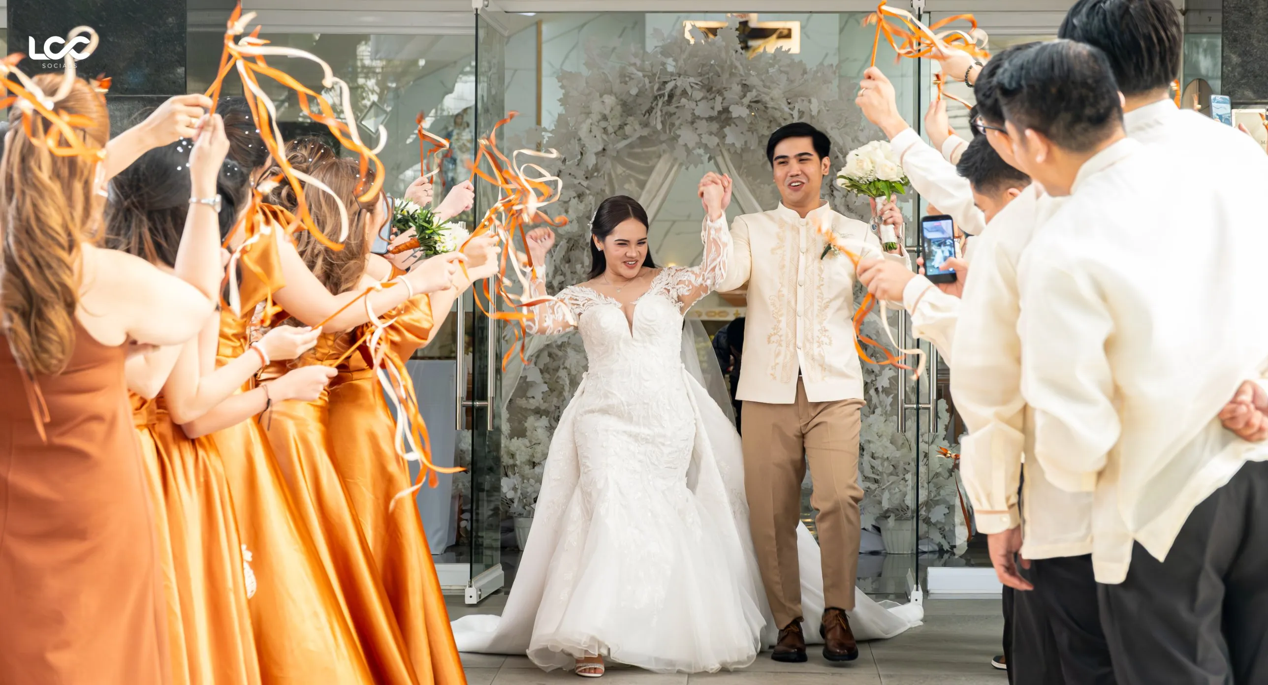 Newlyweds walking through a ribbon send-off