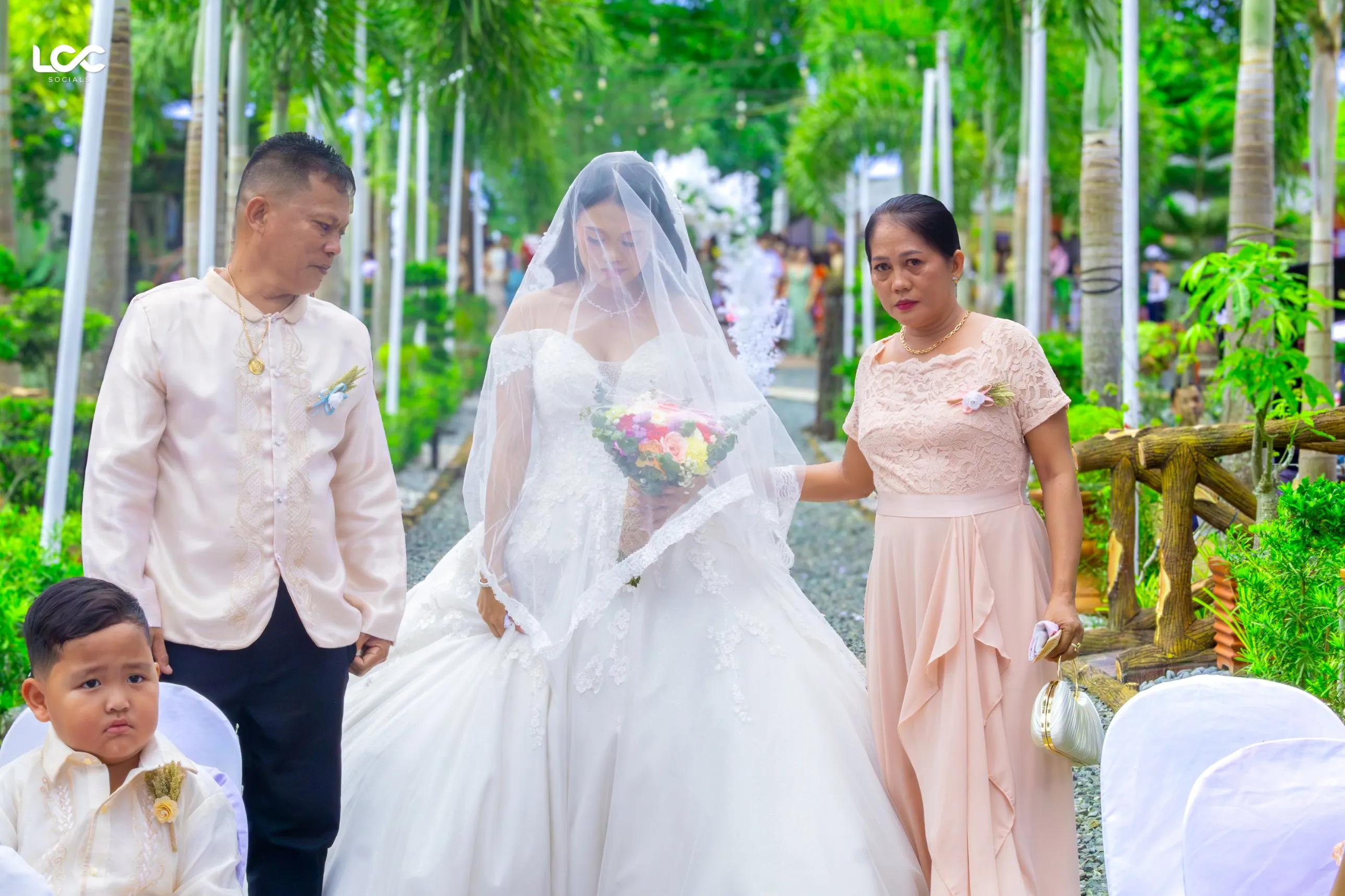 Bride walking down a garden aisle